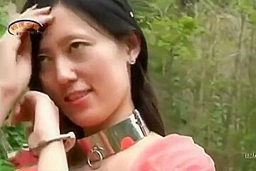 Chinese Beauty In Metal Bondage Outdoors