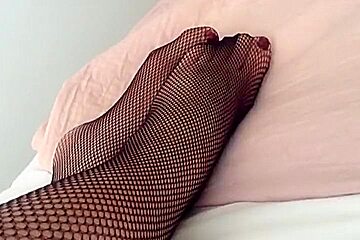 Feet And Legs In Black Fishnet Tights