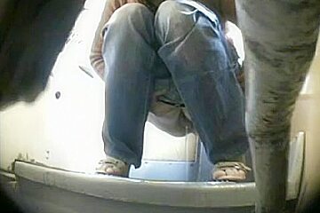 A Fresh Girl Wearing Jeans Is Pissing In The Bathroom